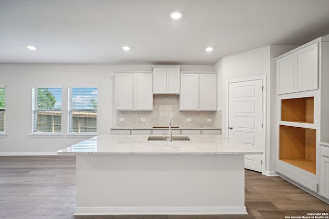 kitchen featuring white cabinetry, an island with sink, and wood-type flooring