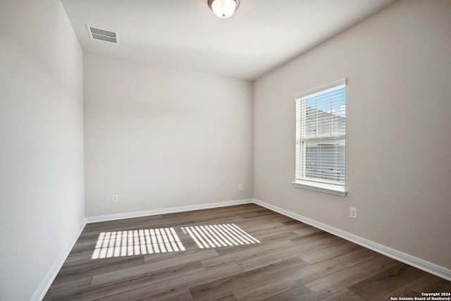 spare room with wood-type flooring