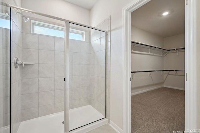 bathroom featuring a shower with shower door