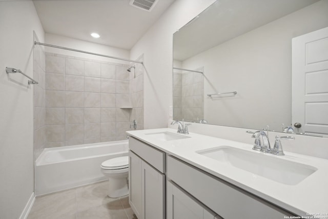 full bathroom with toilet, vanity, tile patterned floors, and tiled shower / bath