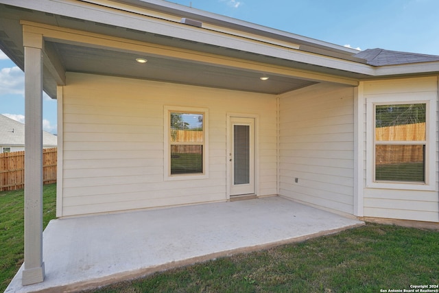 view of exterior entry featuring a patio