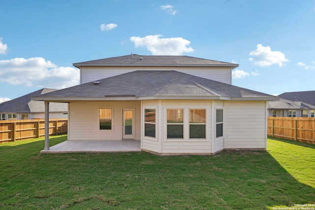 rear view of property with a yard and a patio