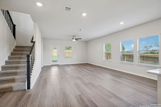 unfurnished living room featuring light hardwood / wood-style floors, a wealth of natural light, and ceiling fan