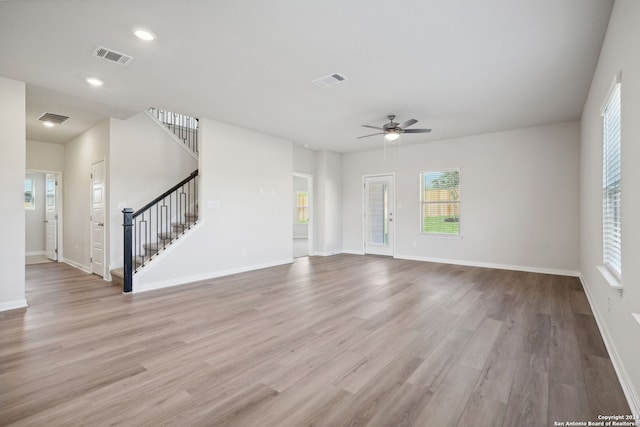 unfurnished living room with ceiling fan and light hardwood / wood-style floors