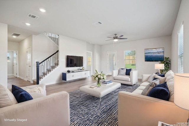 living room featuring ceiling fan and wood-type flooring