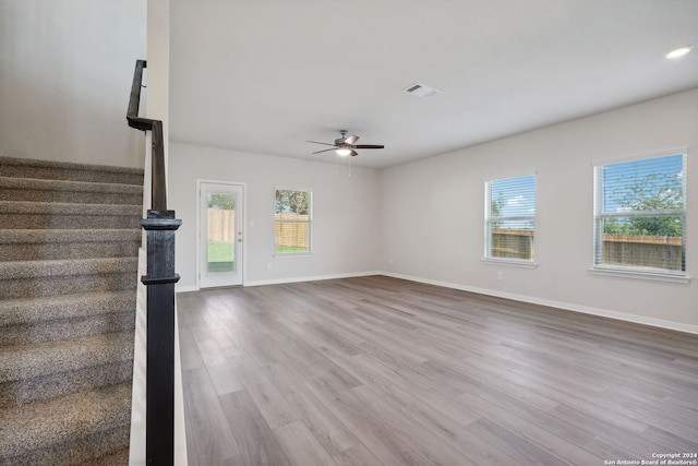 unfurnished living room featuring hardwood / wood-style floors and ceiling fan