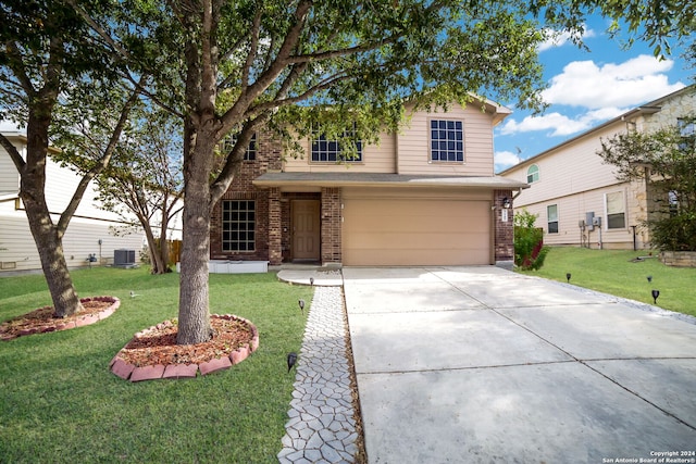 view of front of house with a garage, a front yard, and central AC