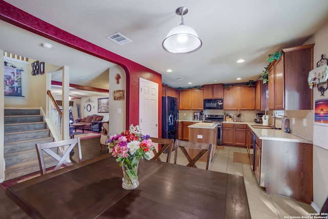 dining area with light tile patterned floors and sink