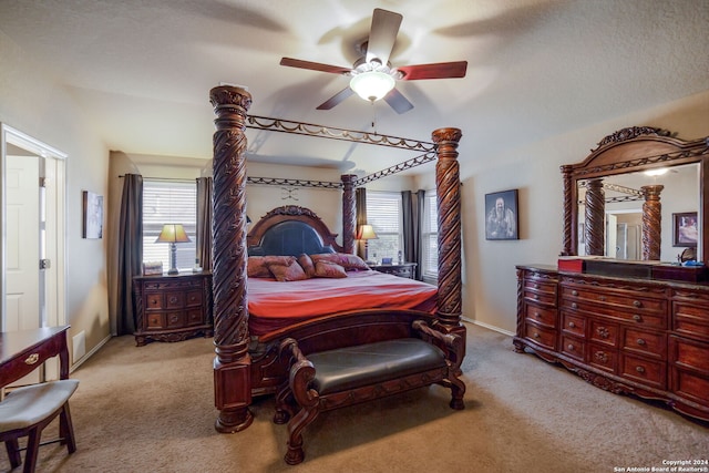 carpeted bedroom featuring multiple windows and ceiling fan