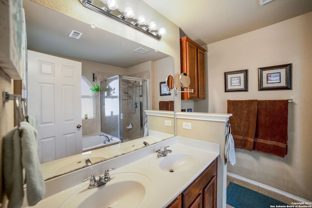 bathroom featuring tile patterned flooring, vanity, and separate shower and tub