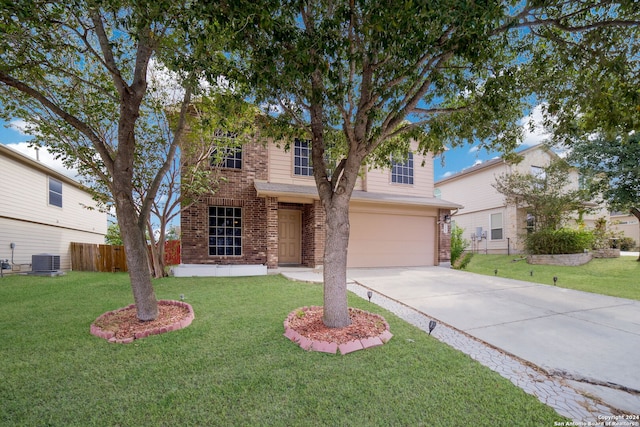 view of front facade with a garage, central AC, and a front yard