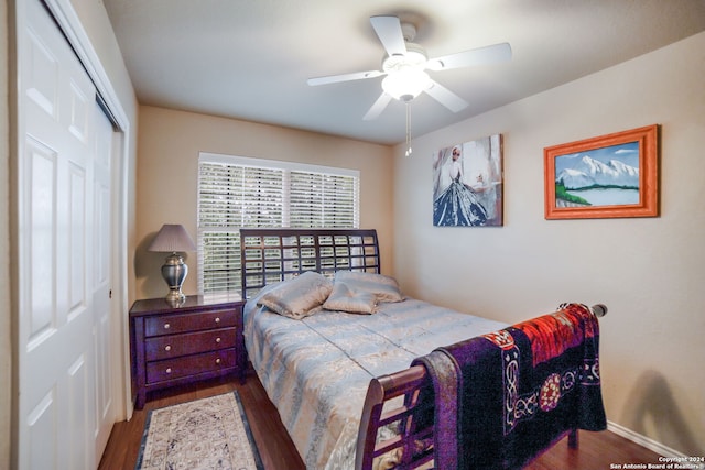 bedroom with ceiling fan, a closet, and dark hardwood / wood-style flooring