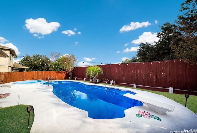 view of pool with a diving board and a patio area