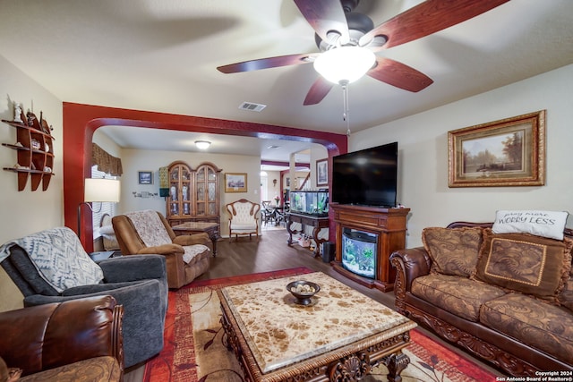 living room with ceiling fan and dark hardwood / wood-style floors