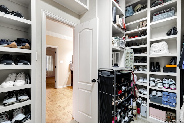 walk in closet featuring light tile patterned flooring