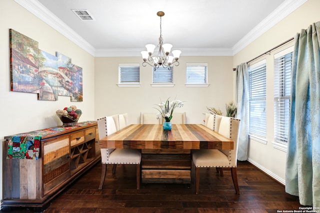 dining area with dark wood-type flooring, crown molding, and a notable chandelier