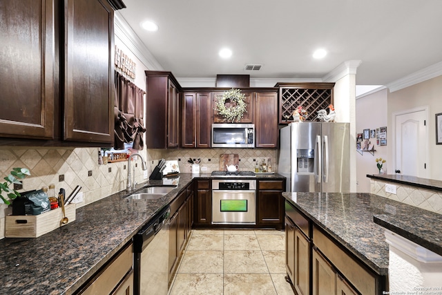 kitchen featuring crown molding, dark stone counters, stainless steel appliances, decorative backsplash, and sink