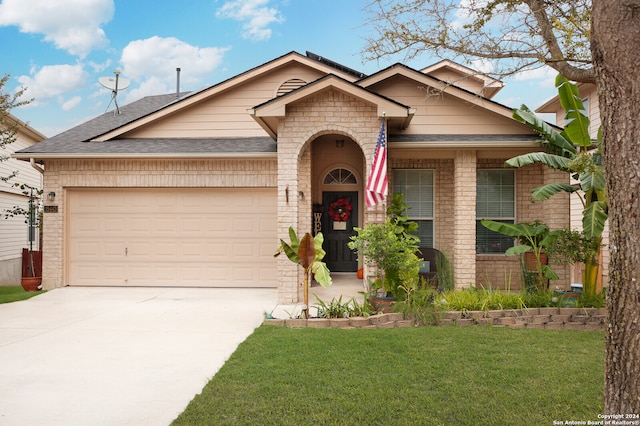 view of front of house featuring a garage and a front yard