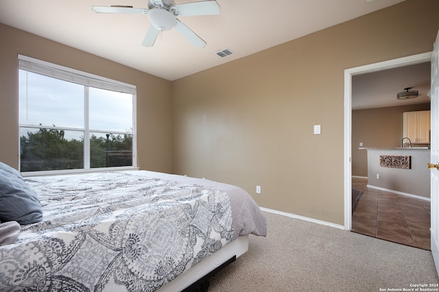 bedroom featuring ceiling fan and carpet