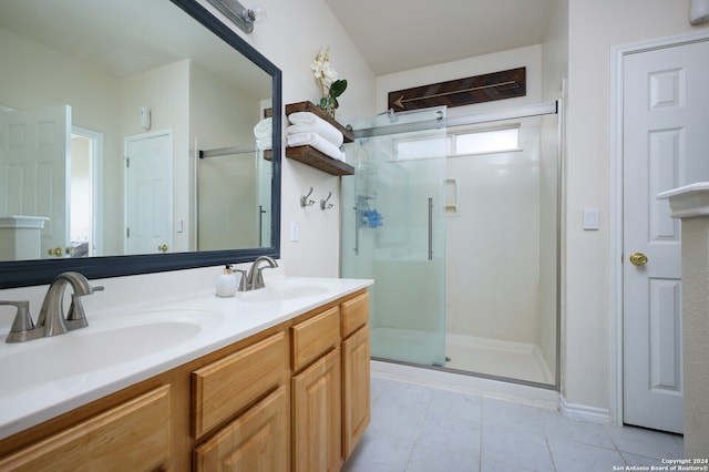 bathroom with vanity and a shower with shower door