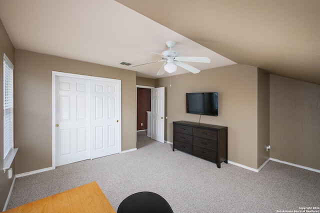 carpeted bedroom with ceiling fan and a closet