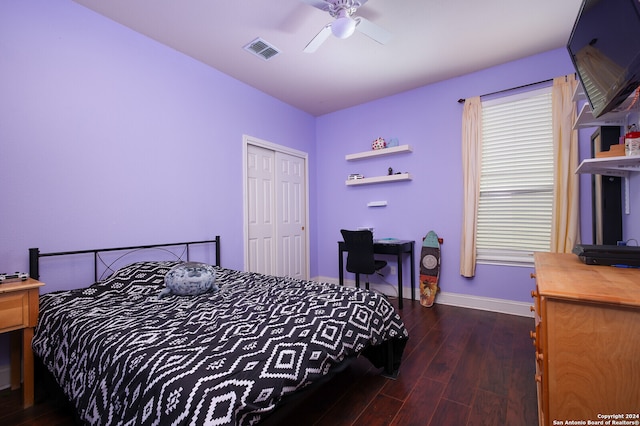 bedroom with dark hardwood / wood-style flooring, a closet, and ceiling fan