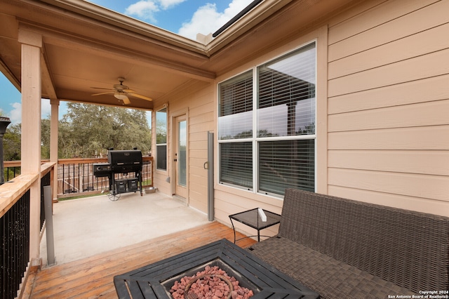 wooden deck featuring grilling area and ceiling fan