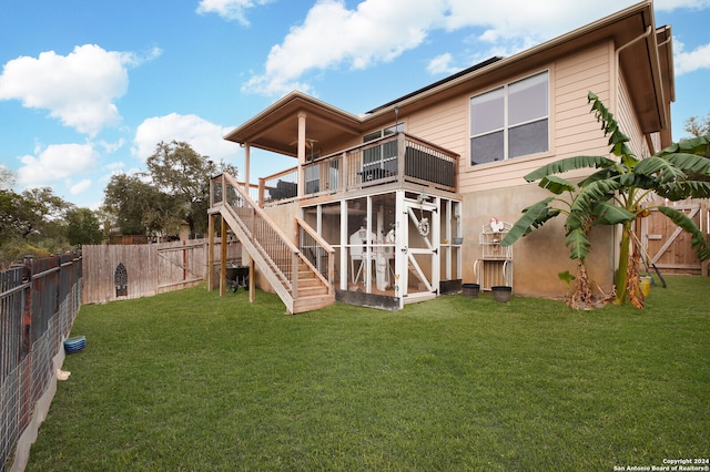 back of house with a sunroom and a yard