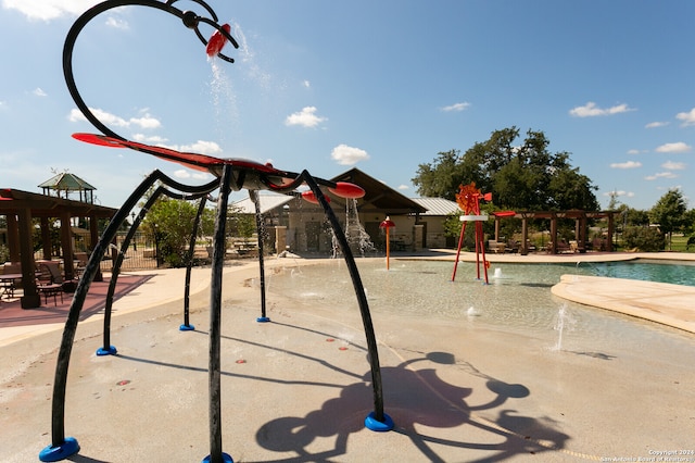 view of playground with pool water feature and a community pool