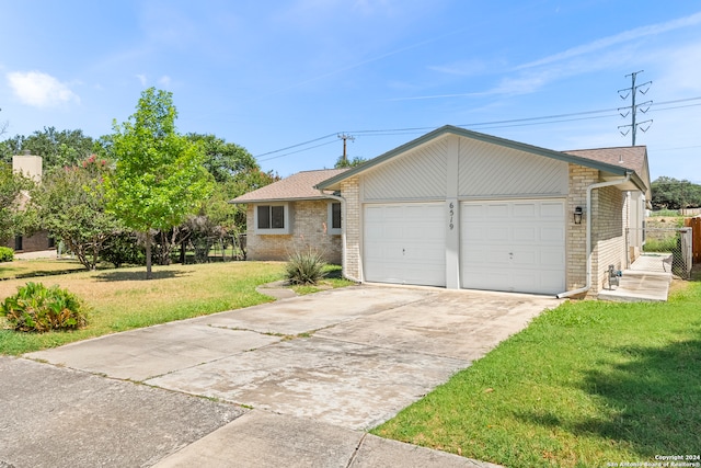 ranch-style house with a garage and a front lawn