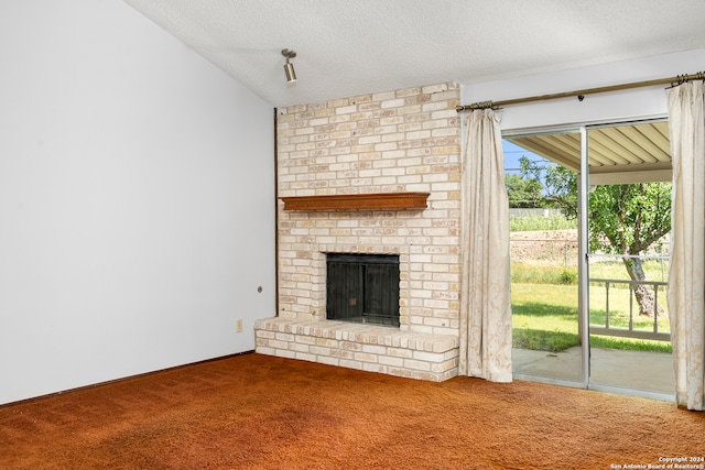 unfurnished living room featuring a fireplace, a textured ceiling, and carpet flooring