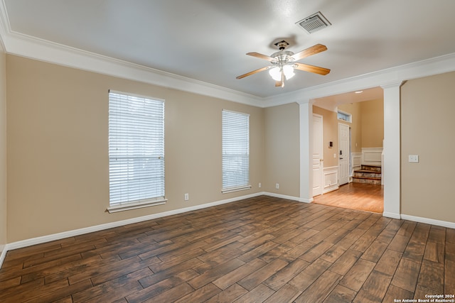 spare room featuring dark hardwood / wood-style flooring, ceiling fan, and ornamental molding