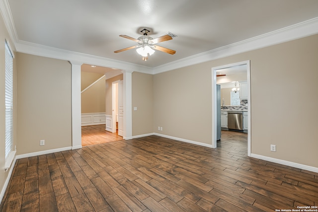 spare room with dark hardwood / wood-style floors, crown molding, decorative columns, and ceiling fan