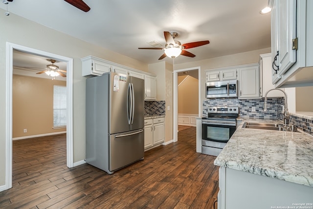 kitchen with tasteful backsplash, stainless steel appliances, white cabinetry, dark hardwood / wood-style flooring, and sink