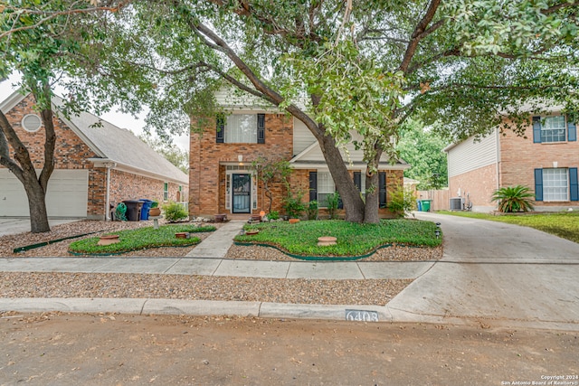 view of front property featuring central air condition unit and a garage