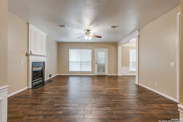 unfurnished living room with a large fireplace, dark hardwood / wood-style floors, and ceiling fan