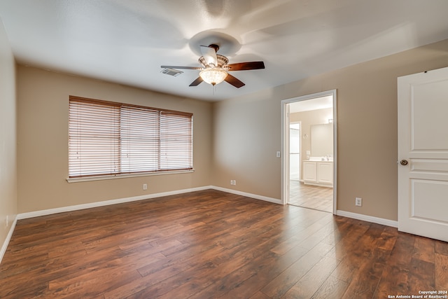 unfurnished room featuring dark wood-type flooring and ceiling fan