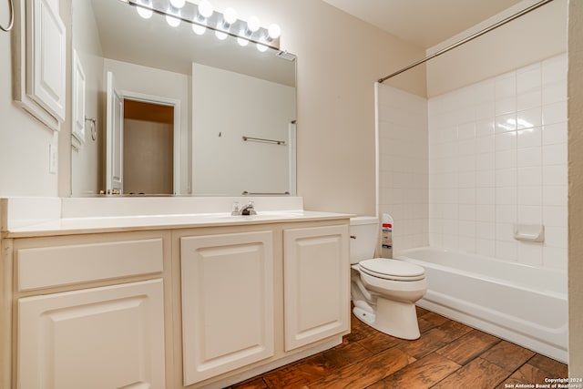 full bathroom with hardwood / wood-style floors, vanity, toilet, and shower / bathtub combination