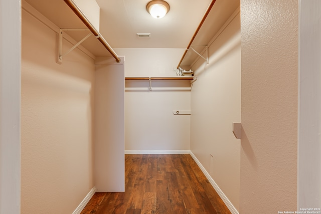 walk in closet featuring dark wood-type flooring