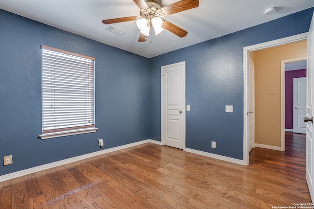 empty room featuring wood-type flooring and ceiling fan