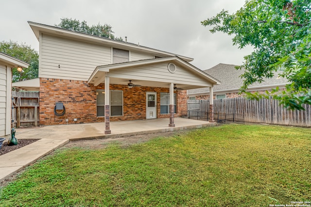 back of property featuring a patio, a lawn, and ceiling fan