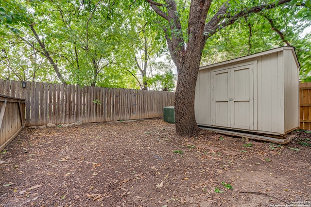 view of yard featuring central AC and a shed