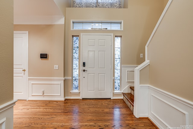 entryway featuring ornamental molding and hardwood / wood-style floors