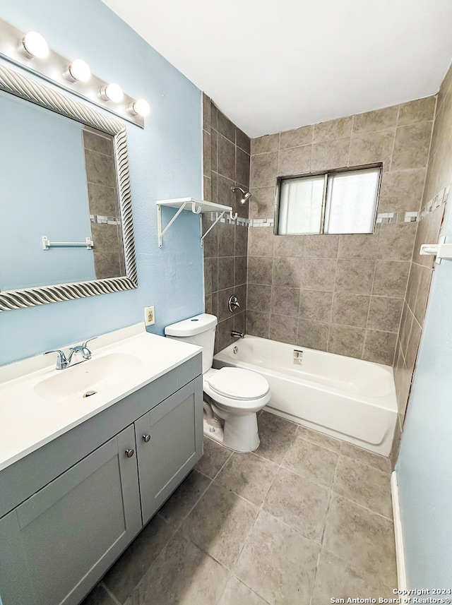 full bathroom featuring tile patterned flooring, vanity, toilet, and tiled shower / bath