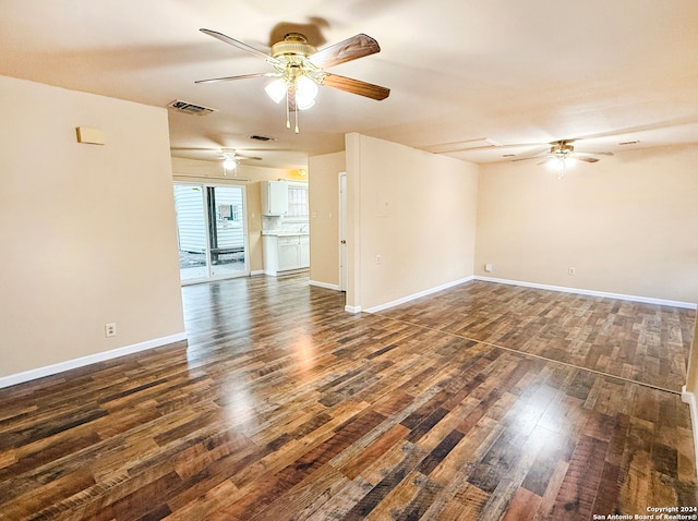 empty room with dark hardwood / wood-style flooring and ceiling fan