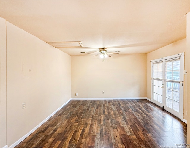 spare room with dark hardwood / wood-style flooring and ceiling fan