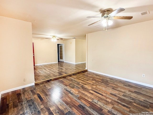 spare room featuring ceiling fan and dark hardwood / wood-style floors