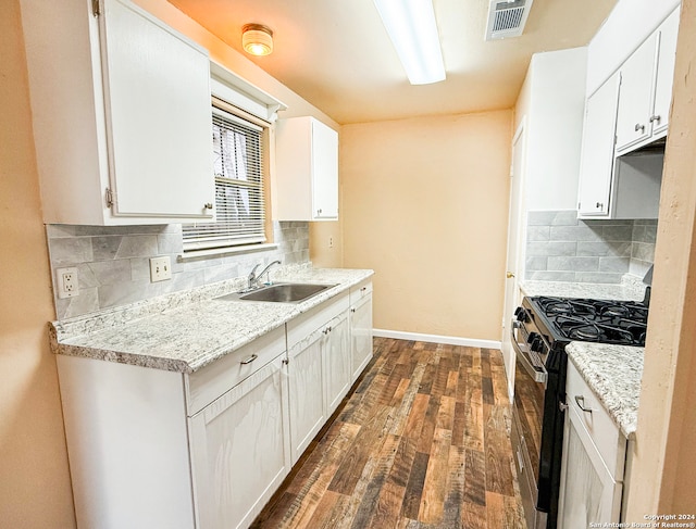 kitchen with white cabinetry, sink, dark hardwood / wood-style floors, and stainless steel range with gas cooktop