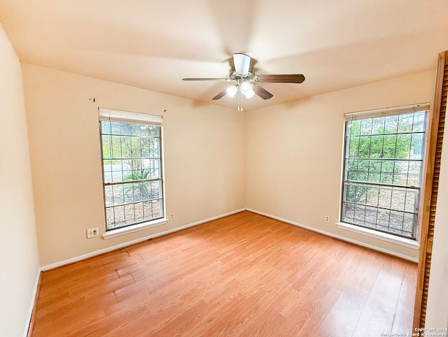 spare room featuring light wood-type flooring and ceiling fan