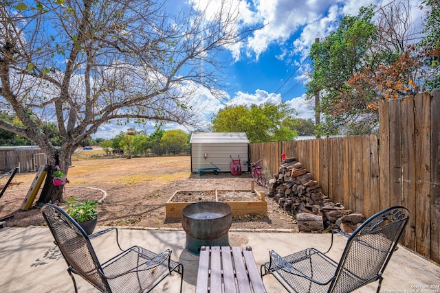 view of patio / terrace featuring a storage unit